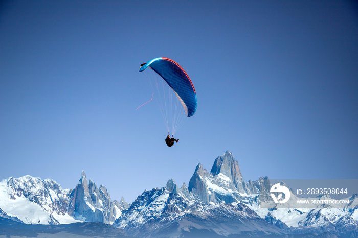 glider paragliding over snowy mountain peaks flying  adrenaline and freedom concept