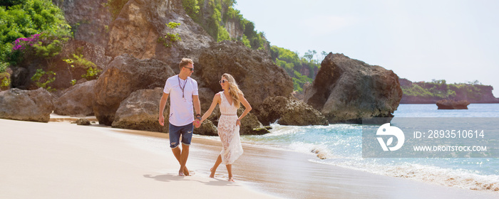 Romantic couple walking on the beach