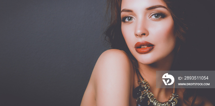 Beautiful woman with evening make-up in black dress