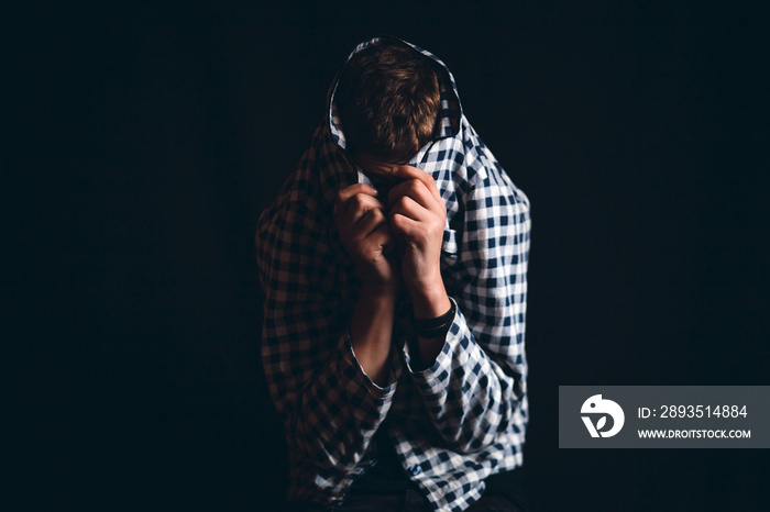 Boy Hiding His Face in Shirt