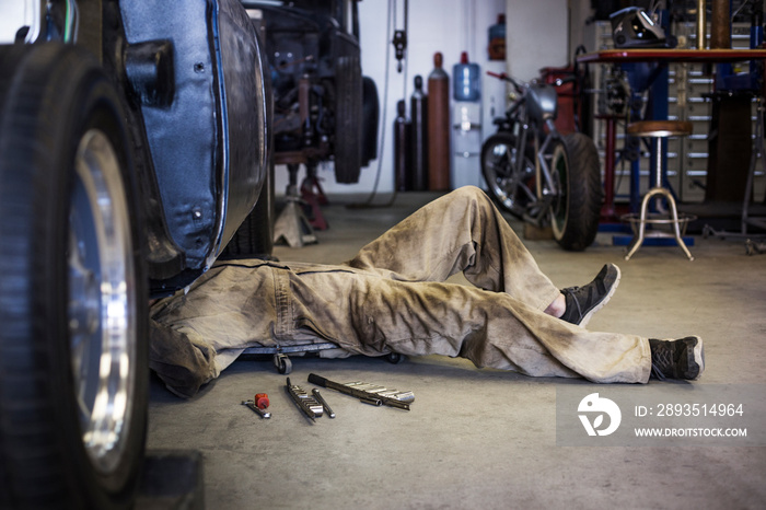 Low section of mechanic working in workshop