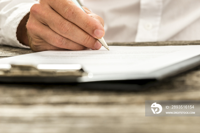 Closeup low angle view of male hand signing subscription form, l