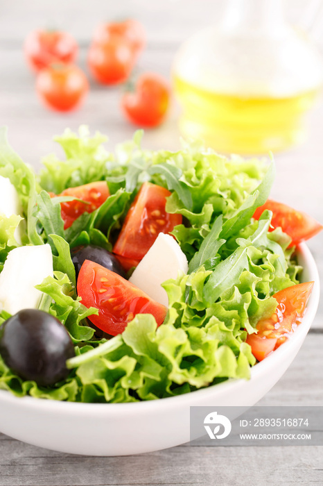 salad with arugula, tomatoes, black olives, lettuce with mozzare