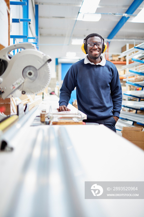 Portrait of male factory worker on production line in roller blind factory