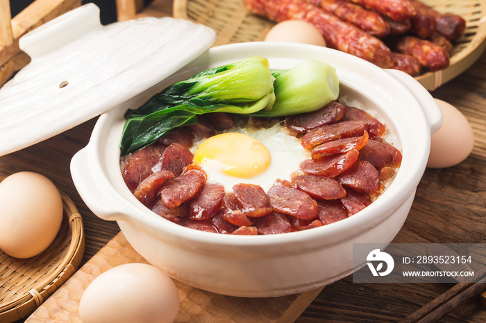 Cantonese style cooking of claypot rice with waxed meats