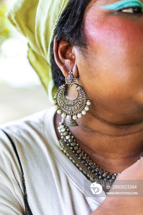 portrait of dark skinned Indian non-binary individual and Indian jewellery