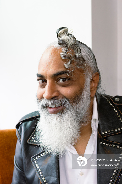 close up portrait of man with gray hair and beard smiling