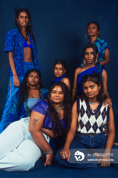 group portraits of dark skinned Indian women from Malaysia against a dark bleu background