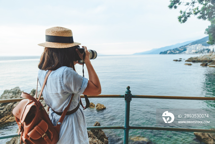 woman taking picture on big camera sea summer vacation