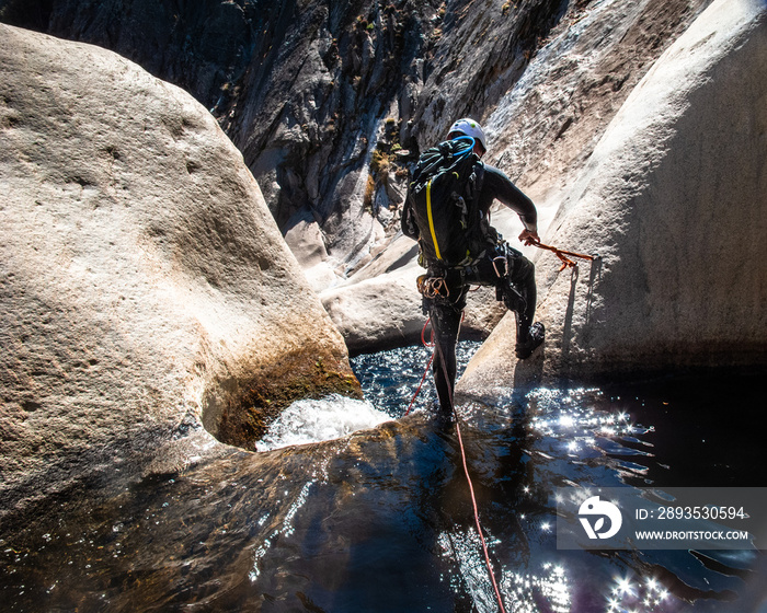 Canyoneer Sets Anchor Above Granite Waterfall