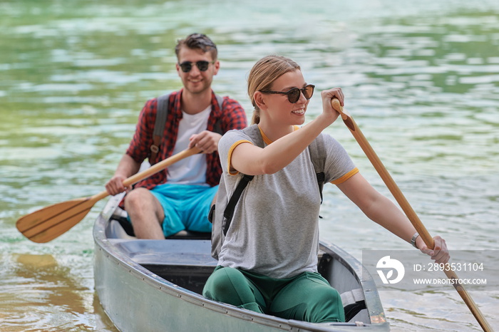 friends are canoeing in a wild river