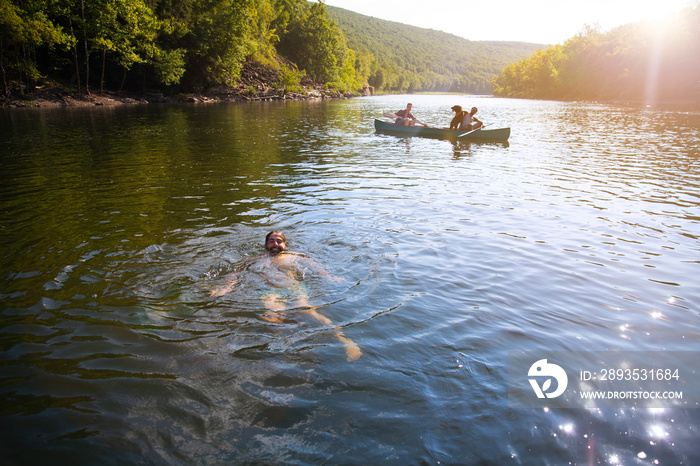 Friends canoeing in river