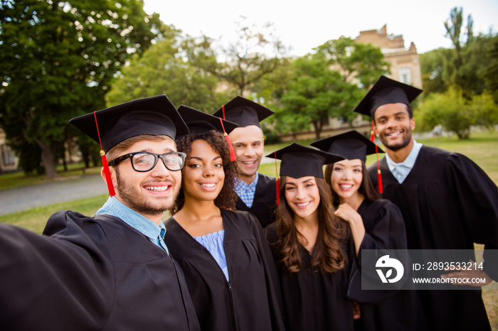 Selfie time! Six international students are posing for selfie shot, that nerdy guy is taking, outsid