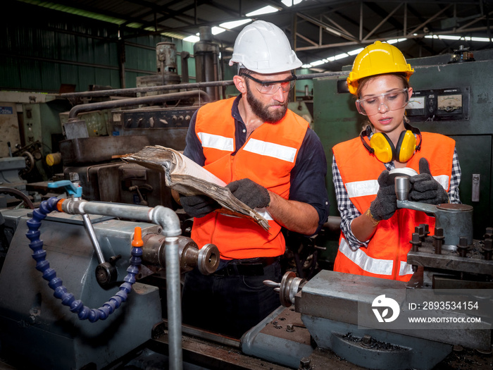 Confident young female mechanical engineer in a protective uniform, helmet while listening to collea