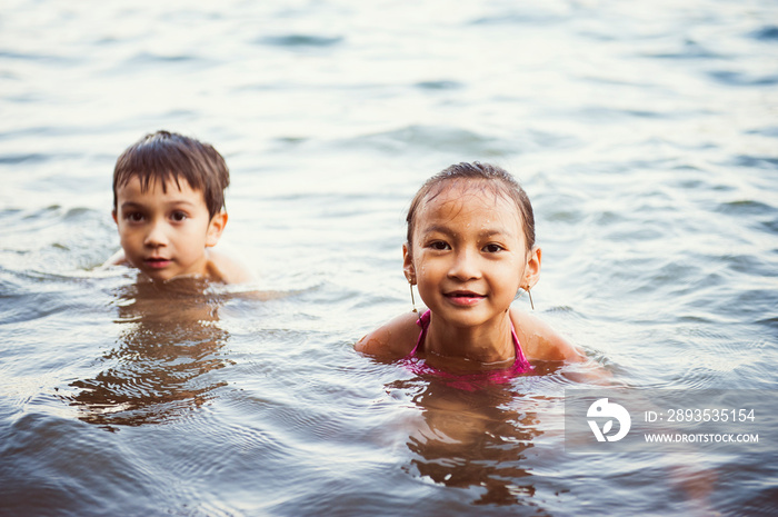 Portrait of children swimming in lake