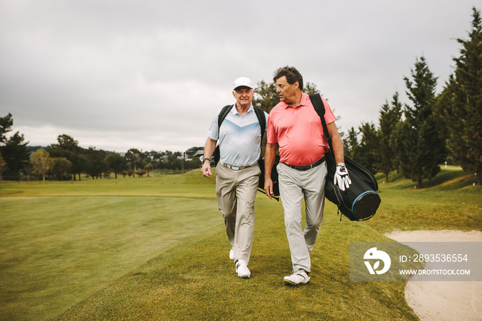 Senior golf players walking together on the golf course