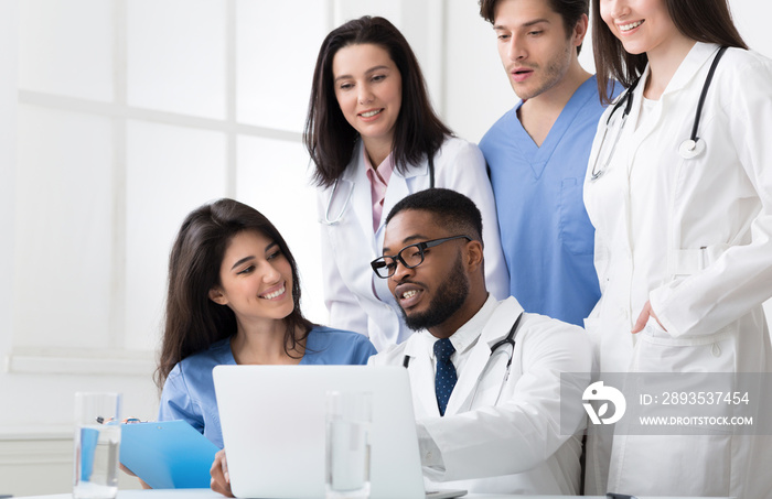 Team of interns and practitioners examining medical reports