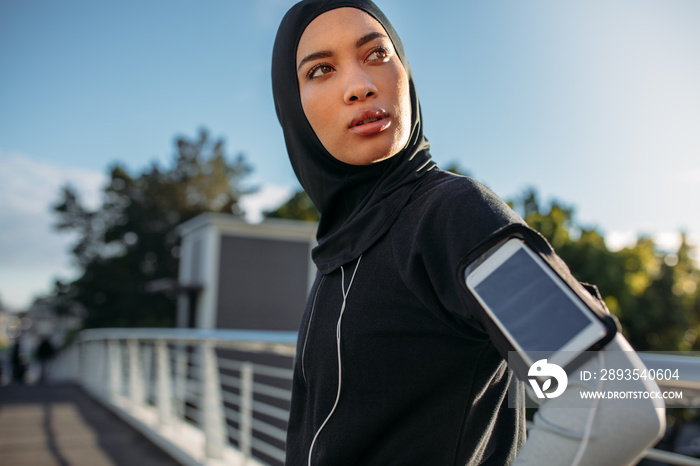 Hijab girl taking a break after workout in city