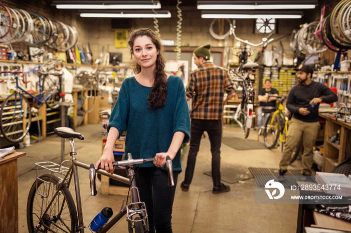 Portrait of young woman in bicycle shop