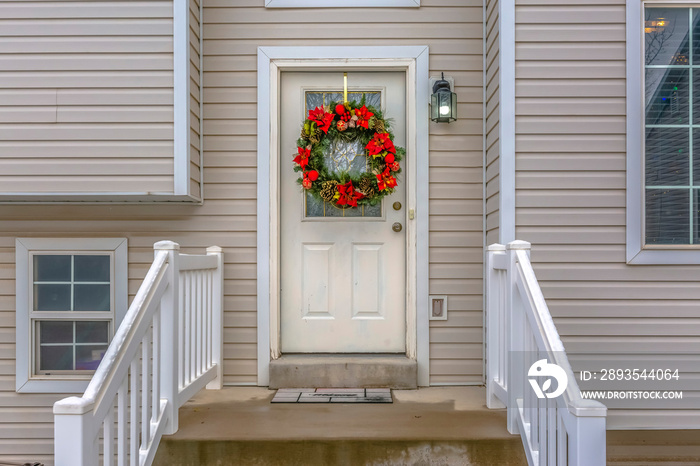 Stairs leading to front door with christmas wreath