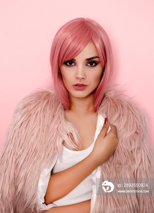 Young woman with pink hair wearing fur coat