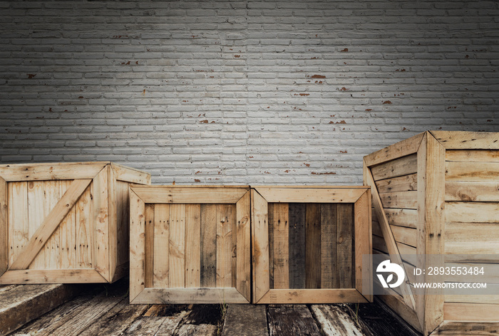 Old wooden box on brick background