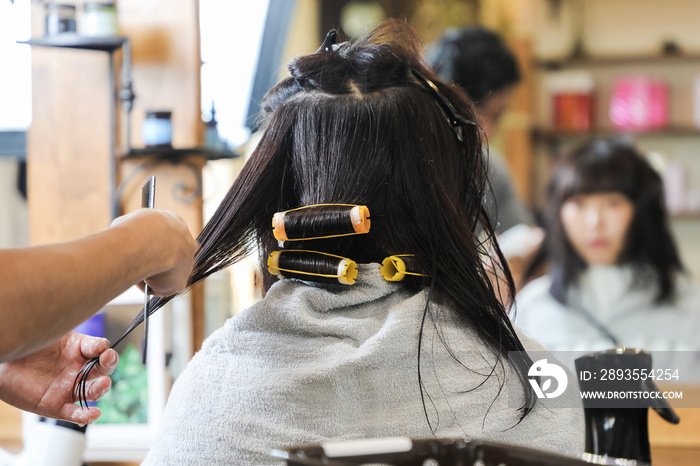 Young asian girl in hair salon.