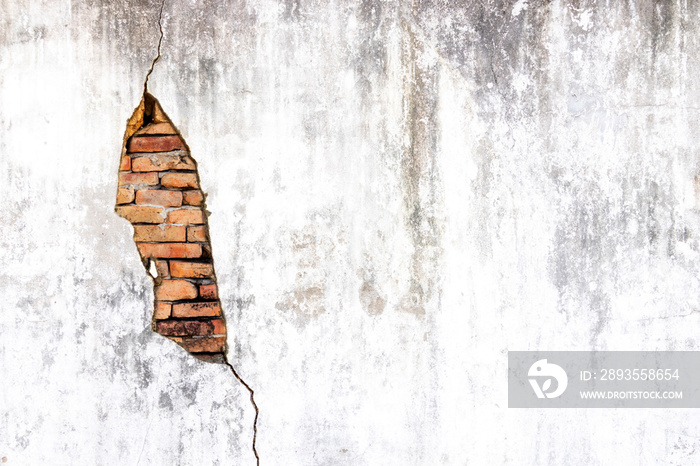 Old shabby white concrete and brick wall cracks. Cracked white cement wall. Old masonry stone bricks