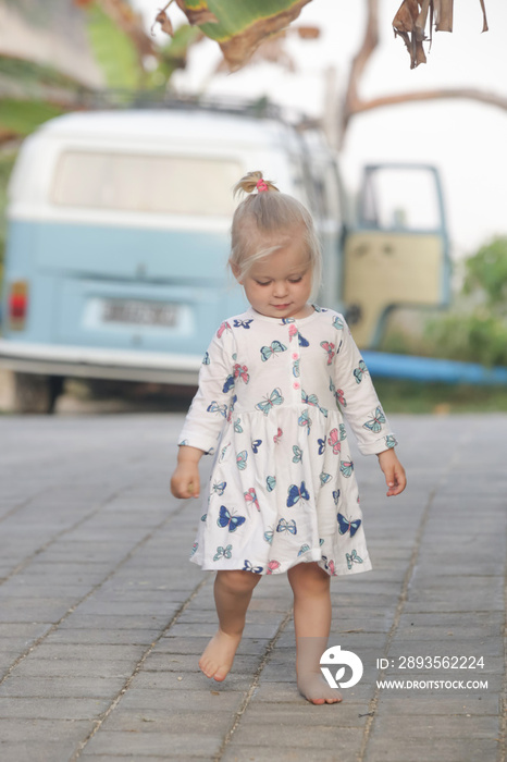 Cute little two years old girl standing on the street