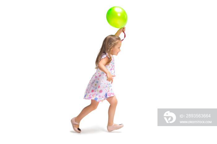 Smiling cute toddler girl three years running over white background