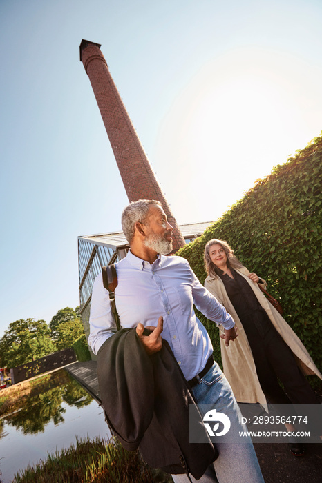 Mature couple walking with holding hands