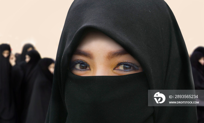 young beautiful and happy Muslim woman in traditional Islam burqa dress with amazing expressive eyes