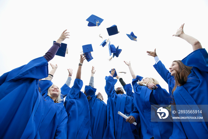 Graduate throwing caps in the air