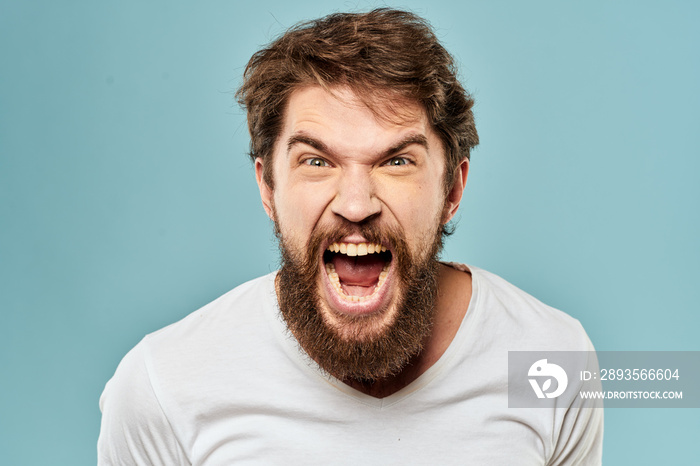 Bearded man emotions facial expression gestures hands close-up blue background