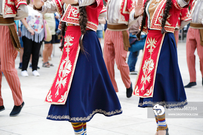 Dancers dancing and wearing one of the traditional folk costume from Armenia.