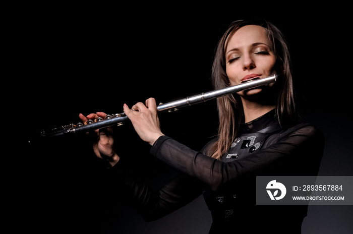 a young girl playing the flute