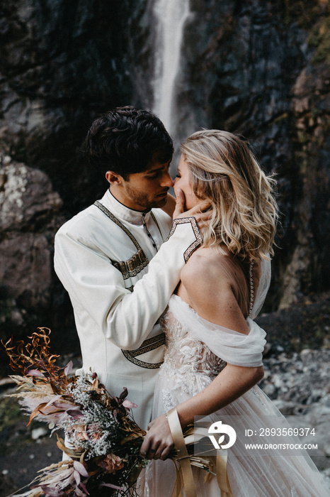 noise effect, selective focus: incredibly enamored brides hugging, kissing and posing for a photo on