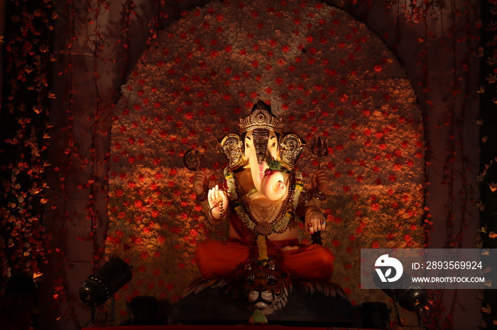 Decorated idol of Lord Ganesha with black background. Ganesh chaturthi/ganeshotsav festival.