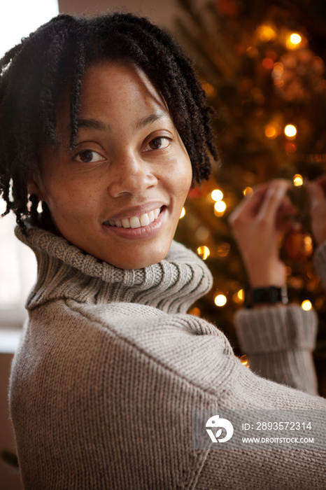 Portrait of woman decorating Christmas tree