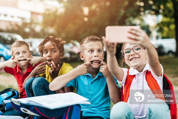 Group of happy elementary school students taking selfie. Primary education, friendship, childhood, a