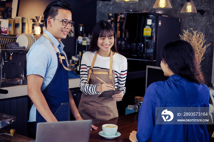 Young asian baristas ordering at counter bar in cafe. Cafe restaurant service, food and drink indust