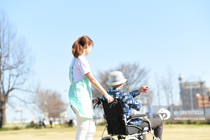 車椅子を押す女性