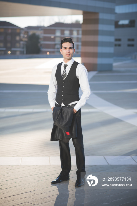 Young businessman carrying jacket