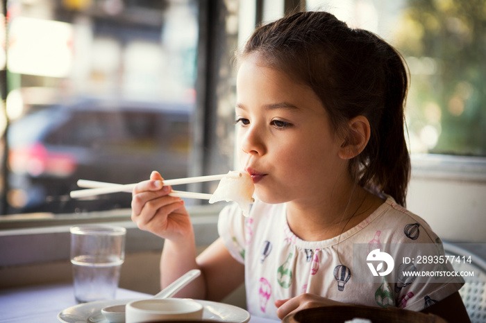 Girl having lunch in restaurant