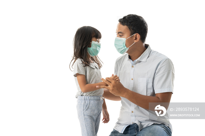 worried father and daughter wearing face mask for virus protection