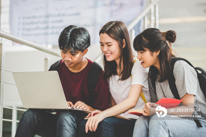 Educational technology and teenage concepts. Group of students sit on the staircase to find informat