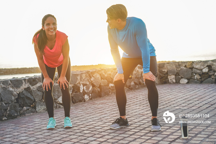 Fit couple taking a rest after fast running workout