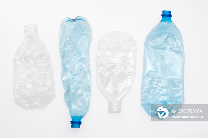 Empty crushed plastic bottles on light background