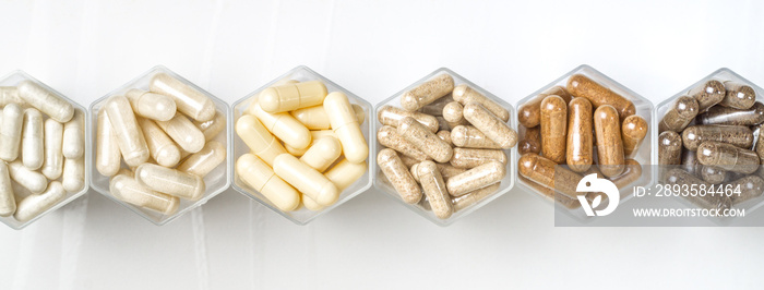 Various herbal and homeopathic medical capsules in hexagonal jars