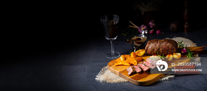 rustic medium butter beef steak with herbs and potato wedges